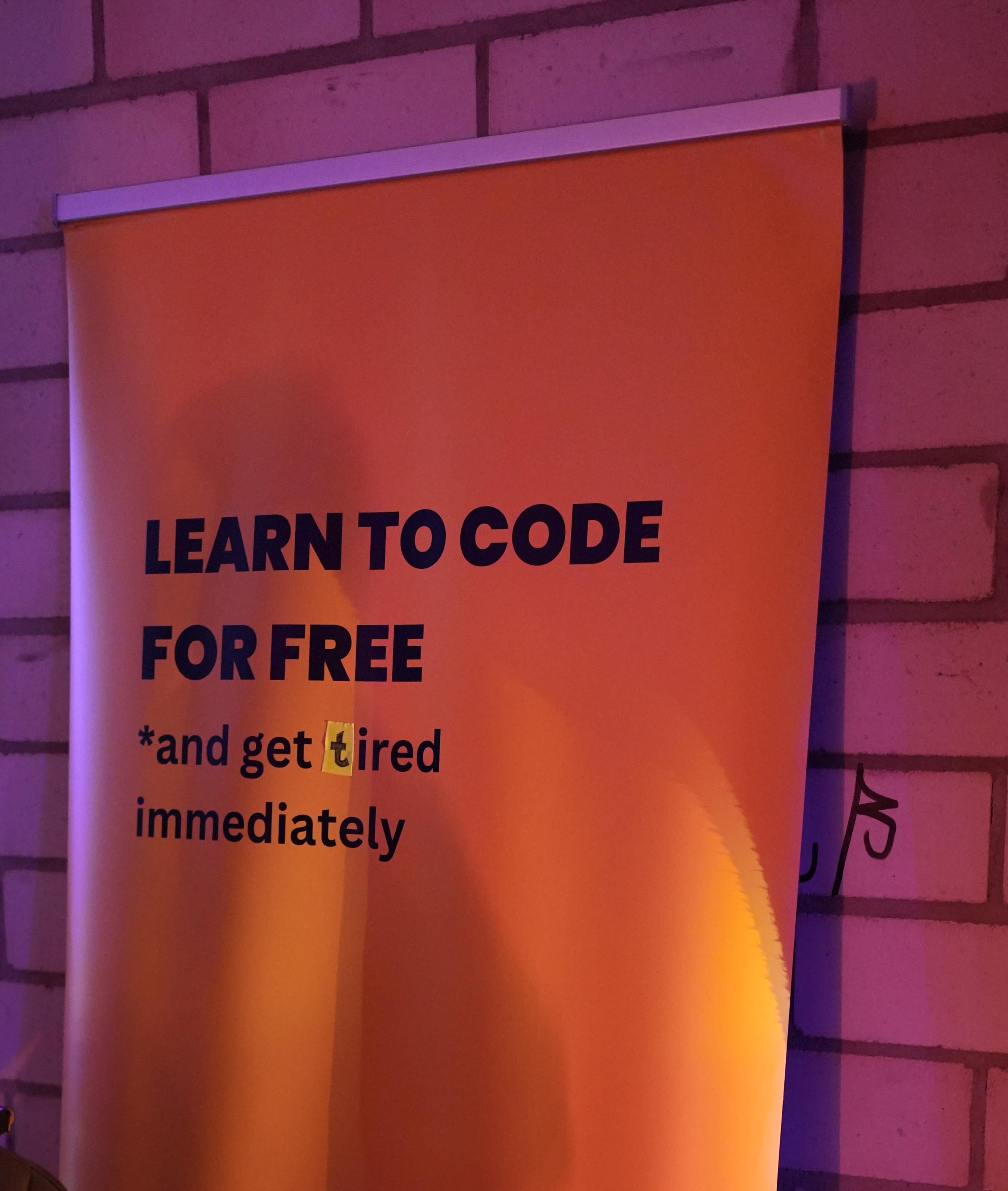 an advertisement with the text "learn to code for free" and the next row "*and get tired immediately". the "t" from tired is replaced and was original a "h", so originally the word was "hired"